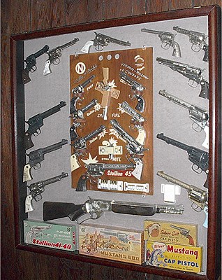 Cap guns cabinet - A collection of cap guns. Cap guns cabinet - A collection of cap guns.