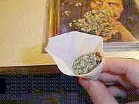 Fill the paper - Fill the cone with your weed and pack it down nicely. You'll need to leave some space so you can wrap the tube with some paper and seal it. Start filing the cone with very fine pieces of grinded weed until its full and even