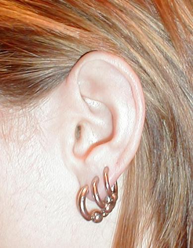 My gauged earlobes - In this pic I have 8ga, 10 ga, and 12ga captive hoops.