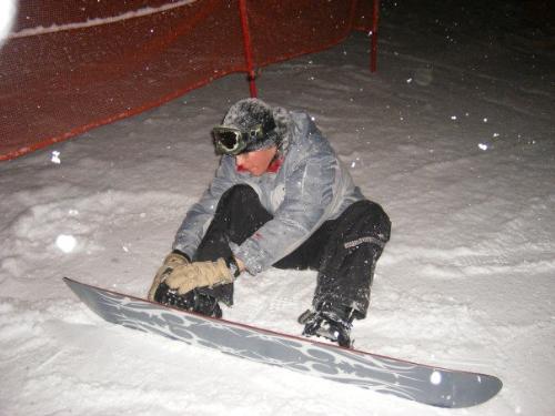 Me strapping into my snowboard. - This is me strapping into my snowboard before bombing the first run of the day.