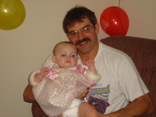 Proud Poppy with Granddaughter - My husband with our Granddaughter on her first birthday.