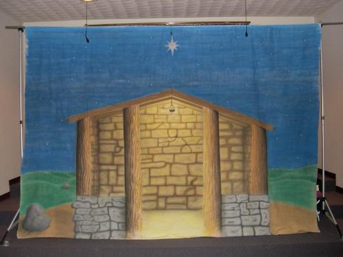 Nativity backdrop completed - The longest explanation of this stable airburshed back drop is in the Nativity Stage backdrop in the making photo. This was the completed back drop. Some people when they walked into the church thought we had built a stable on the stage until they got a closer look.