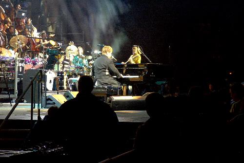 Elton John at the Birmingham NEC. - Elton John picture playing (check out Davey playing his heart out in front of EJ). This is at the NEC in Birmingham, UK when he had full orchestra and choir support. Simply amazing!