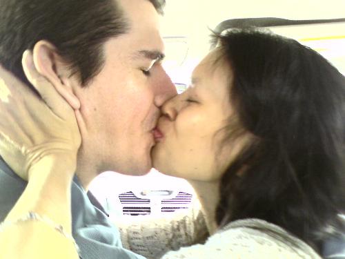 Smoochy in the car... - Hubby and children (and I) were driving around in the car one day and our 11 year old daughter took this picture with her cell phone. So far, it's definately one of my favourite pictures of all time.