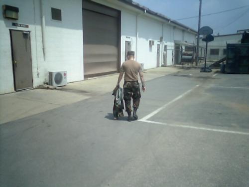 Worn out Soldier - Soldier walking inside to hide from the blazing sun.
