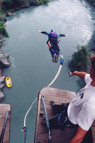 bungee jumping - This is a bungee jump over water. The person will come to rest about 20 feet above the water, from where he is lowered into a waiting raft.