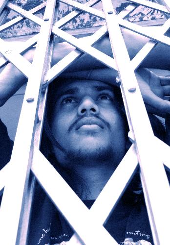 me behind the bars of creativity - a guy standing behind a slider n seems to be thinking.  Seems to be very neat composition n a gr8 pic too.