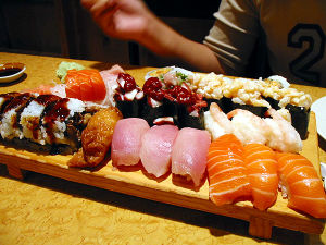 Sushi - Sushi a famous Japanese dish. rice and cucumber or avocado wrapped with seaweed, dipped in soy sauce for additional flavour
