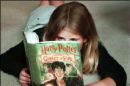 a girl reading a harry potter book - a girl reading the book harry potter & the goblet of fire