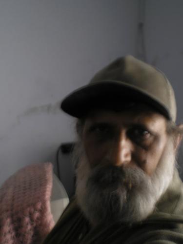In between beared and cap - This is a photo taken while one talk was on and light and shadow were litle low but has a good result regarding expression too!