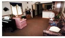 Living Room - This is a common room for the residents in a local nursing home. It has a nice television, comfortable furniture, attractive drapes. There is a stereo system, and books and gadgets to keep various residents happy and at ease. it is a good area to visit with family.