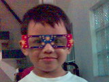 my son - it's my son, playing with rainbow eyeglasses made out of paper