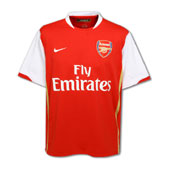 Arsenal FC Jersey - Official team shirt of the Arsenal Football club. Red and white, with gold lines at the sides and 'Fly Emirates' emblazoned on the shirt.