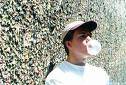 chewing bubble gum - In this pic is a guy joyfully munching away his gum and making his bubble.