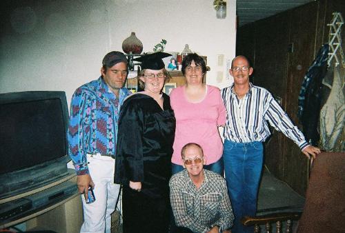 Picture of the group - This is a picture that was taken along with my graduation. It has my mom, dad, fiance, and max and me in it.