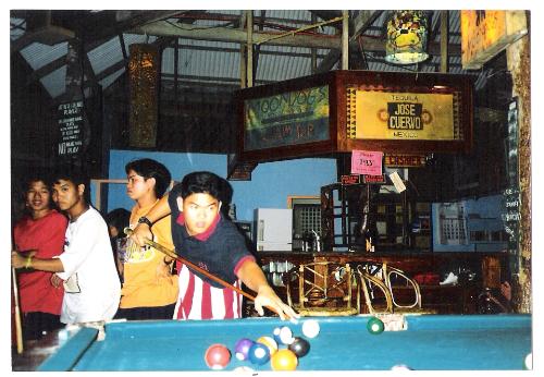 on a rare occasion that i went out with friends - this is me playing billiards in the island of boracay, philippines
