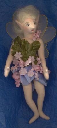 Cloth Fairy - This is a little 7' Flower Fairy, made from cloth and her clothes are silk flower petals and leaves. Her hair is natural mohair and her face is painted with acrylic craft paints.