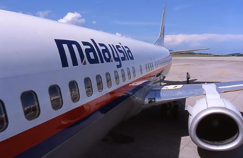 Pre-flight inspection - A Malaysia Airlines pilot performing aircraft inspection prior to takeoff. 