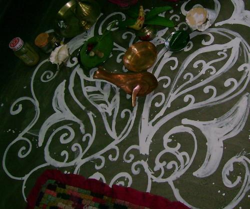 saraswati-puja rangoli - This photo was taken at the saraswati puja held at my home.The seat of the Goddess Saraswati is decorated by making designs by the ladies.This art is developed and perfected over the years by ladies from their childhood.