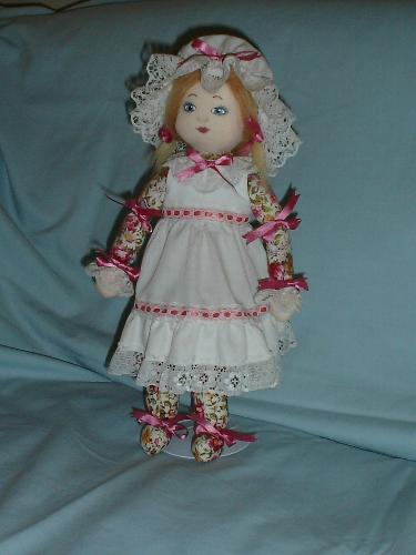 Marigold...a cloth doll - This is one of my cloth dolls; her body is a print, tied at the wrists and ankles to make hands and feet, her head is peach velour, with features done in acrylic craft paits. Her hair is fake fur.