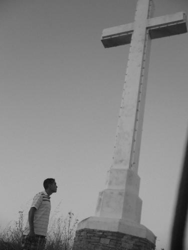 Cross at a Cemetary - This is photograph taken by my friend, with me in the picture. This is in Hayward, California, in the San Francisco Bay Area where a huge cross sits on top of hill. Me and my friends went up to it to take some pictures and I particularly like this one. How about you?