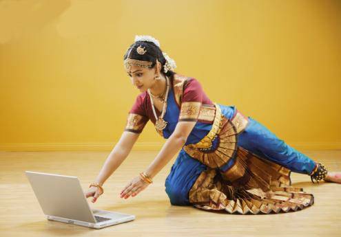 reach of technology - one can see the women in the pic wearing bharathanatyam costume and working in a computer