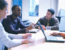 People in a meeting - People working in a meeting with a computer