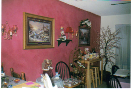 Decorated Dining room - The wall was sponged with a sponge roller using a couple of different colors of paint and going over the wall several times, it took about 4 days to complete.  The Little bar table and stools were picked up at a garage sale for $10 they were like brand new.  The picture closest to the camera I picked up at Sam's club for $49.99 not bad price. The one next was a gift at Christmas. The candle sconces were purchased years ago through a Home Interiors party that I went to, I think they were about $50 total for the glass globes (6) and 2 brass sconces.  All the knick knacks on the shelf and the little decorative table came from bargain stores and garage sales or were gifts. The bar table had a few of my beanies from my collection.  The tree in the corner was purchased years ago at a furniture store for about $70.00. Our local flea market sells the same stuff for half that price and they are brand new items.  The wine rack was from someone I knew and they were throwing it out, just my luck.  I love candles and think they add a lot to any room so I do use a lot of them through out my home.  Hope this helps and gives you some ideas.