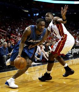 Washinton Wizards - Gilbert Areanas drives on a Miami Heat defender.