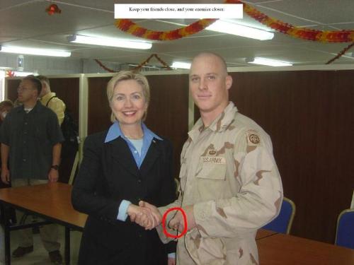 Hillary visits Iraq - soldier giving coercion sign Hillary visits Iraq - soldier giving coercion sign