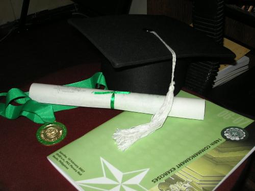 happy graduation - these are stuff from my graduation. there's the toga hat, the programme, the diploma and the medal!