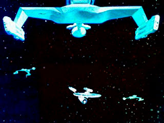 Enterprise Surrounded by 3 Romulan Battle Cruisers - Taken from 'The Enterprise Incident' in which Captain Kirk takes the Enterprise into the Romulan Neutral Zone & then finds himself surrounded by thre Romulan ships. These Romulan ships were the design of Klingon D7 battle cruisers.