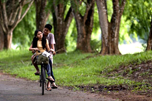 Mukhsin & orked - riding a bike along the villange