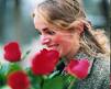 Lady with Flowers - A Lady smiling, with a bunch of Roses in hand.