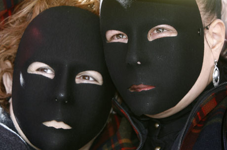 Women's Day - Abused women wear black masks as they protest during a rally to mark International Women's Day at Madrid's Puerta del Sol March 8,2007.
