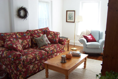 My living room - My floral sofa is the accent piece for this room. The room has a bright, airy feeling!