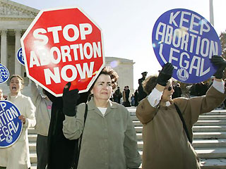 Protesters on the abortion issue. - Pro and anti oppinions abut the legality of abortion.