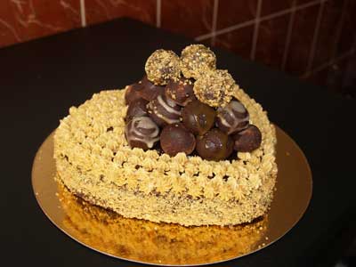 buttercream cake with chocolate and strawberry jam - Buttercream cake i made. The cake has a chocolate ganache filling as well as strawberry jam... covered in ganache and buttercream on top. chocolate truffles to top it all off