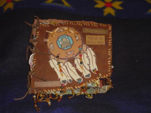 I made this book. - This book is made of leather, paper, lace, water color paint, beads and embroidery thread. It contains photos of a weeklong camping trip with boyscouts at Camp Hansen in Kansas. It was a lot of fun designing and took me a month to put together in my spare time.