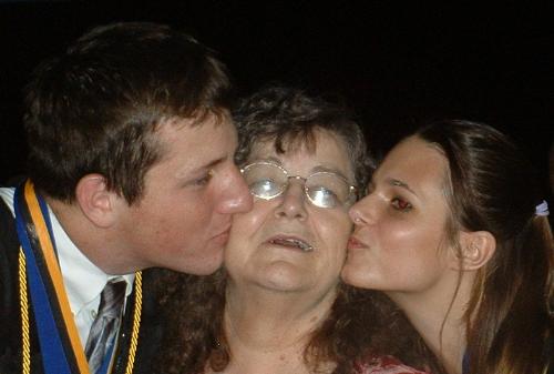my kids and mother - My oldest two kissing my mother at their graduation!