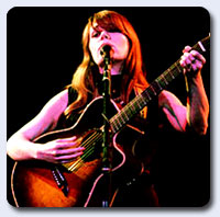 Jenny Lewis - A picture of Jenny Lewis playing the guitar