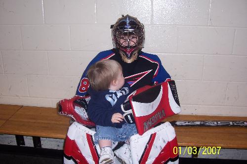 Hockey - This is my hockey goalie holding his younger brother. His brother is scared of him in all that gear.