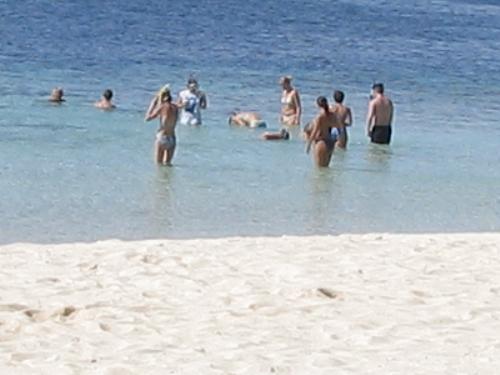 foreign tourists  - foreign tourists enjoying the white sand and crystal clear waters of banana island.