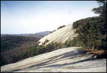 stone - The first cliffs are visible after a quater mile of climbing.Slide trails to the right lead out to nice views of the rolling hills of the North California Piedmont.