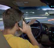 Driving with a Cell Phone - man driving a vehicle while talking on a cell phone.  no headset.