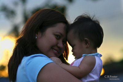 Bonding at Sunset - This picture was taken weeks before my daughter Erika's first birthday. It was a special bonding moment for me and my little girl who I almost lost at birth. The sunset happened only for seconds but my photographer friend captured the moment perfectly. I love this picture as I love being a mother to my baby girl