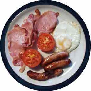 How yummy is your breakfast? - A yummy picture of a sumptuous breakfast consisting of egg, ham, tomatoes, and sausages. A bit on the oily side though.