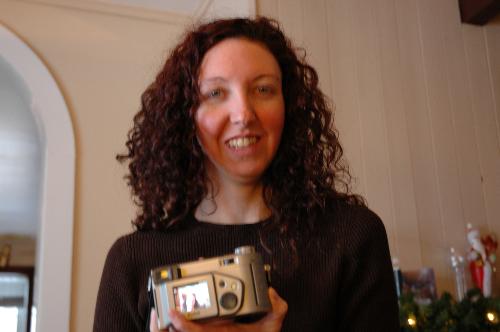 Me at christmas - This is photo of me at christmas getting one of my gifts at christmas a new camera and awaiting the many more presents to arrive. I think I love christmas in terms of the weather over here is a little cold for my liking now that spring is almost here I'm happy.