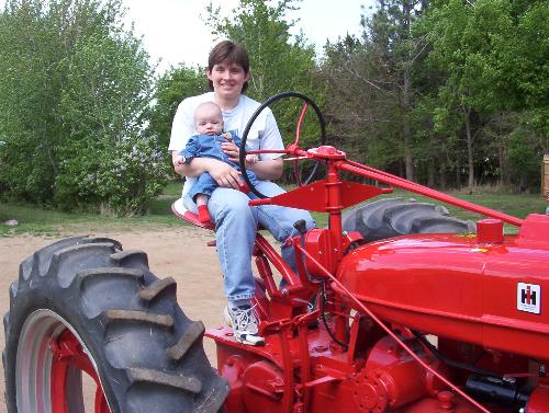 Our Son and our antique tractor - Here is Lisa and Jacob sitting on the antique tractor Keith restored!