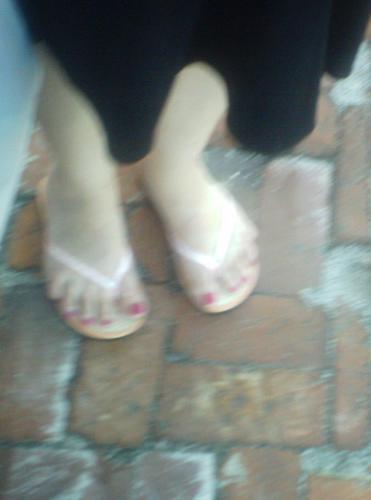 feet and flip flops on a coble stone street - My friends feet in her newly aquired flipflops (high heels and cobble stone a big no no)